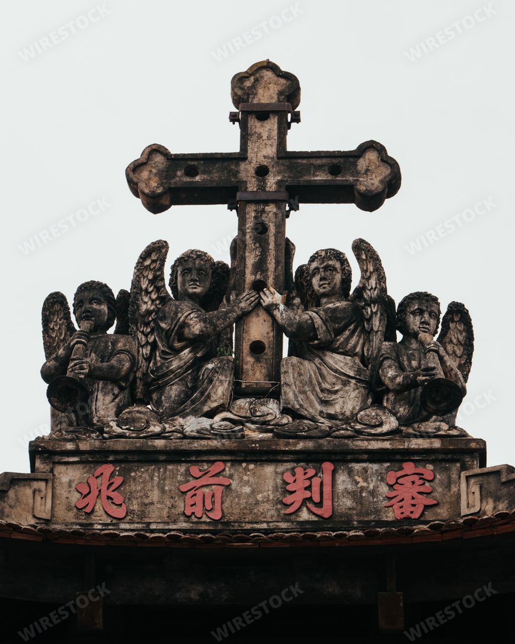 An exterior view of ancient cross and angel sculptures at Phat Diem Cathedral, near Bai Dinh in Northern Vietnam