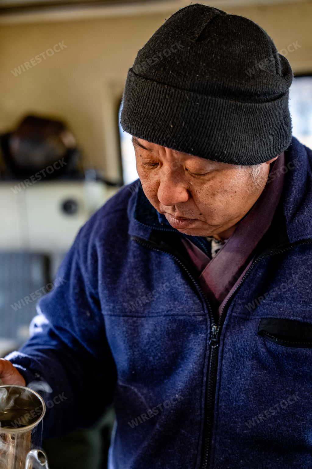 Japanese man making pourover coffee in a converted school bus coffee shop. Winter time in Fuji Fujikawaguchiko Japan.