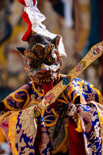 A Tibetan Buddhist in traditional demon ghost clothing during a ritual dance