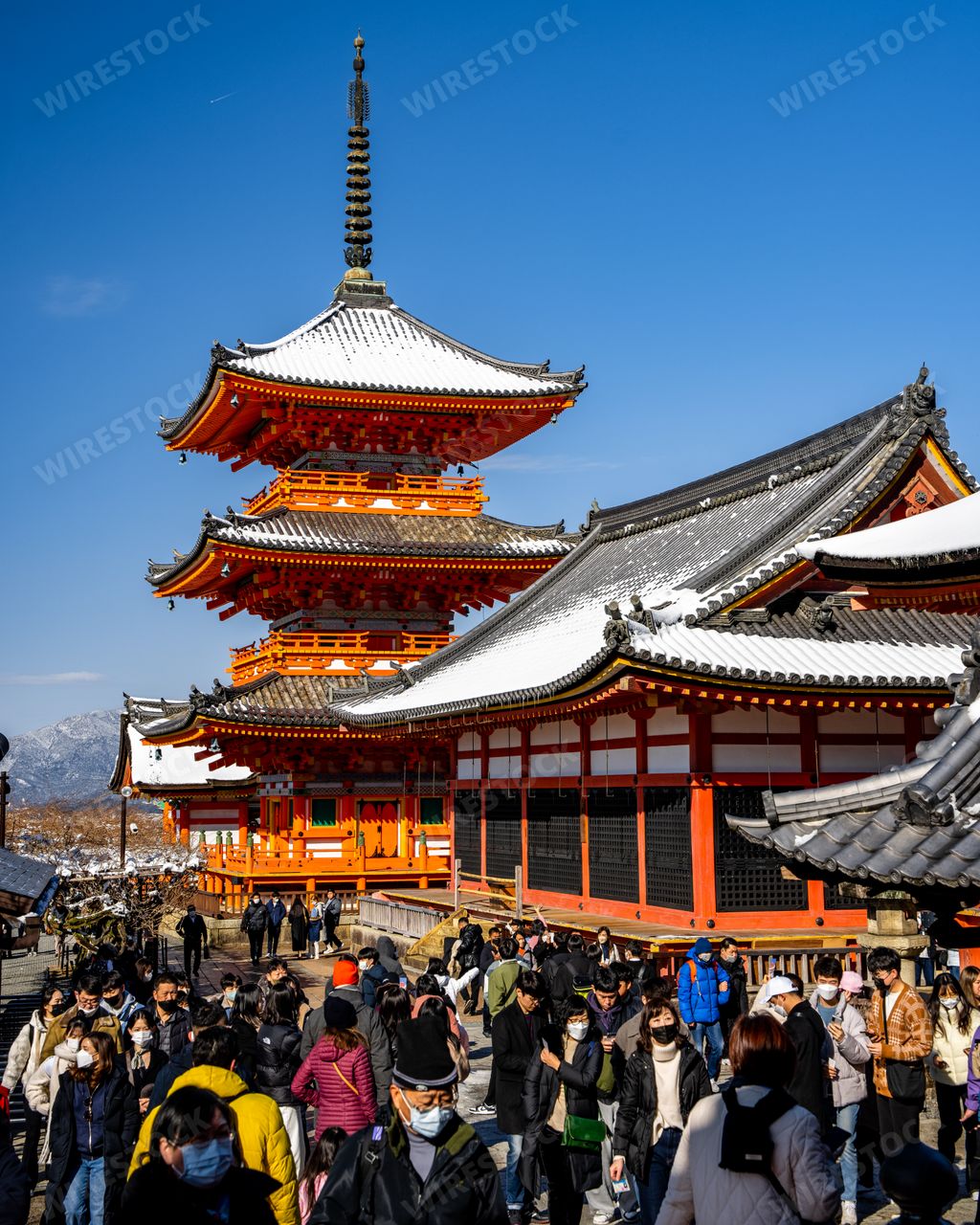 A View of Japanese people crowd at rare snow covered Kiyomizudera Temple with ancient pagodas, gates, and temple complex in Kyoto Japan