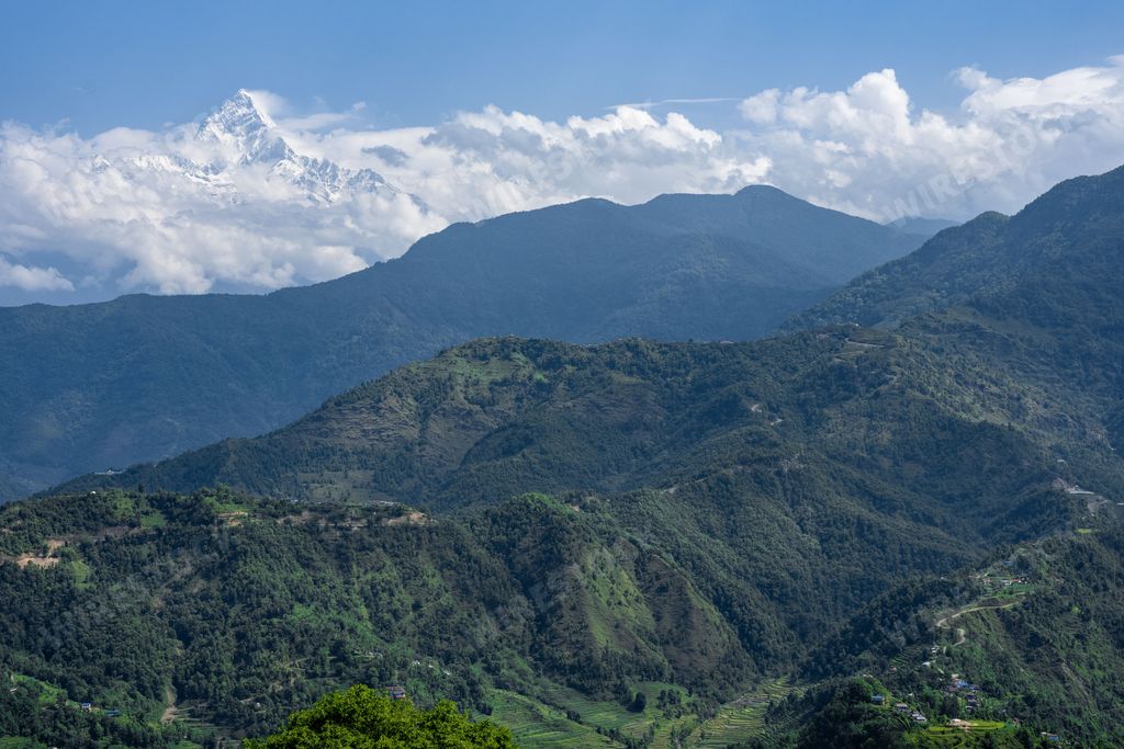 The Machapuchare AKA Fishtail Mountain green hills, Himalaya Range, Nepal.