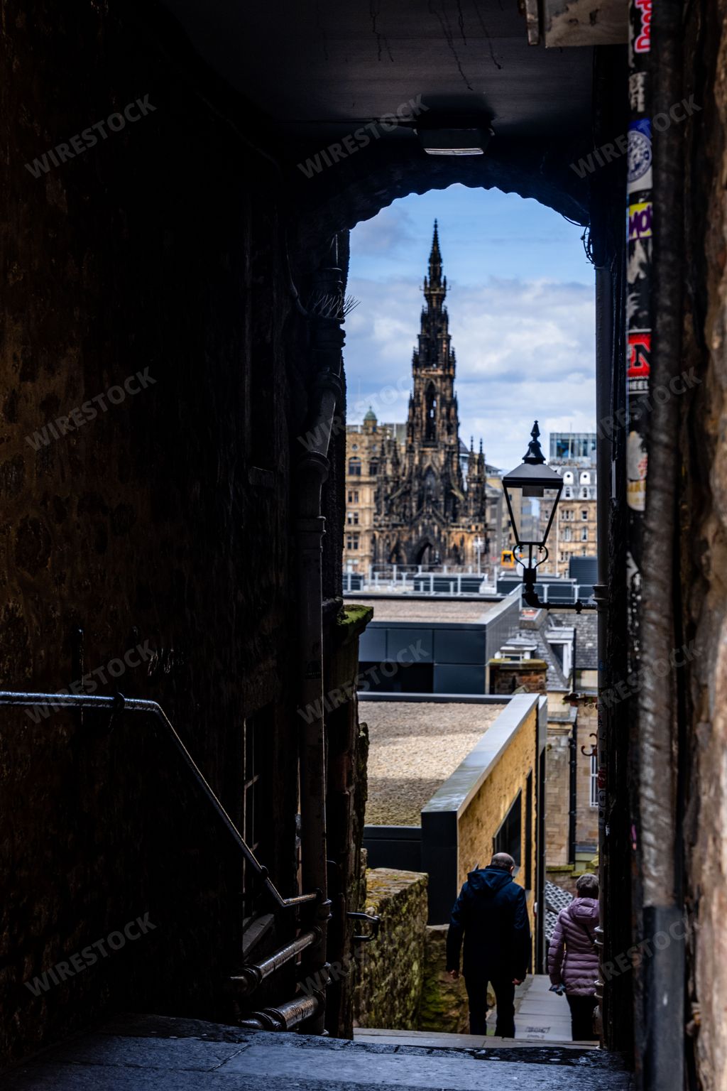 An alley with Scott Monument in view on the royal Mile in Edinburgh, Scotland UK