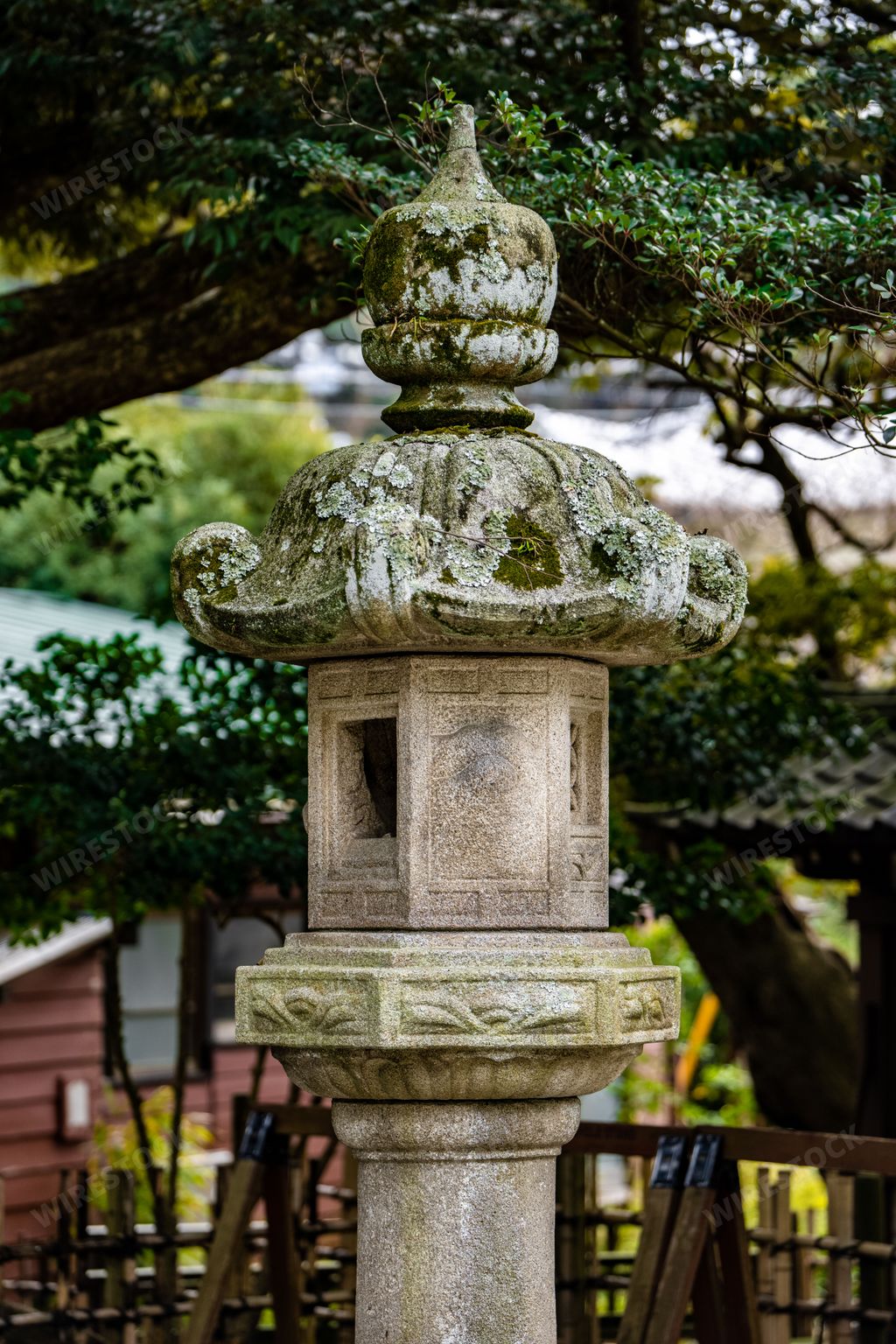 A Japanese Ishi-doro stone lantern in Japan and trees in the background