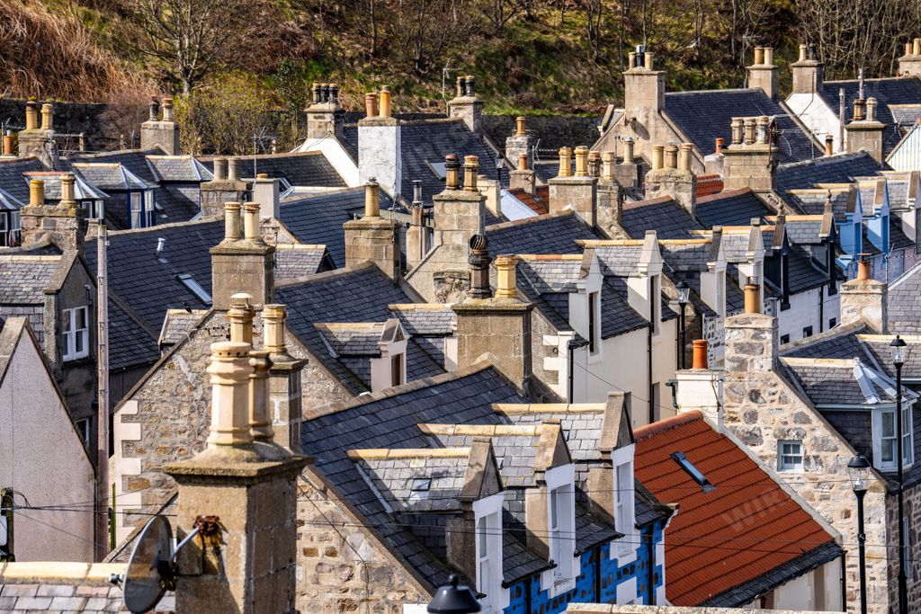 View of the small coastal town village of Buckie, Scotland UK. Quiet streets, homes, and cottages with chimneys and stone building.