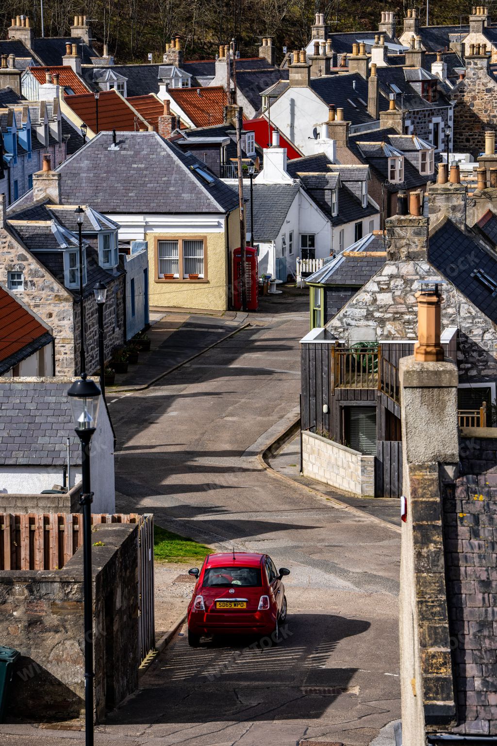 View of the small coastal town village of Buckie, Scotland UK. Quiet streets, homes, and cottages with chimneys and stone building.