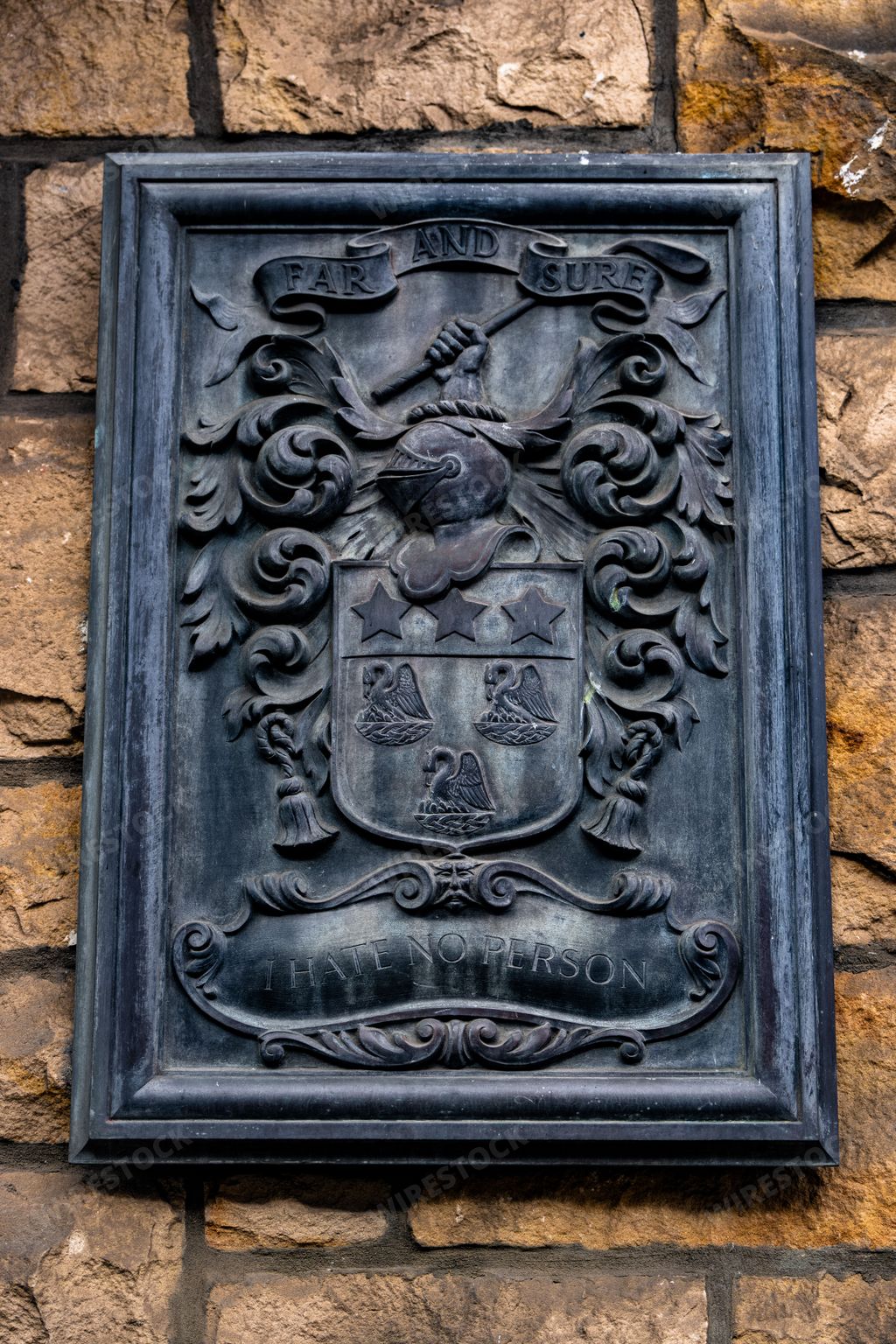 An old crest on a stone wall in Edinburgh Scotland UK
Texts on the crest: FAR AND SURE, I HATE NO PERSON