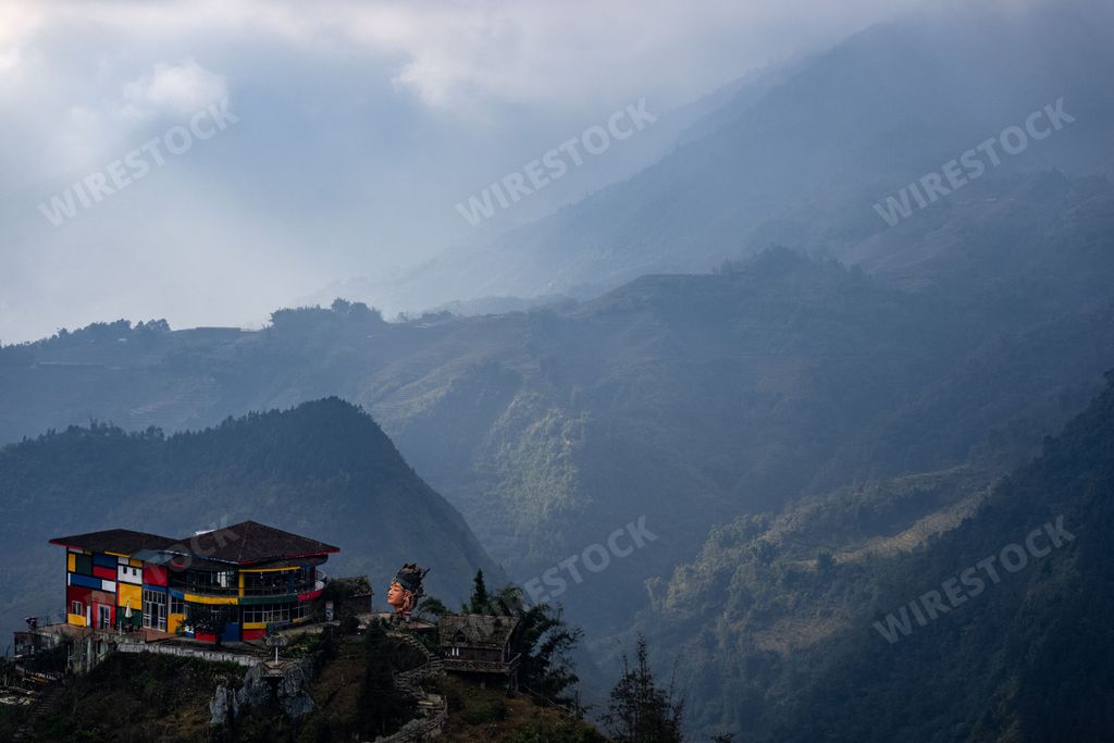 A picturesque dirt road winds its way through a rural landscape lined with small, rustic houses: Sapa, Northern Vietnam