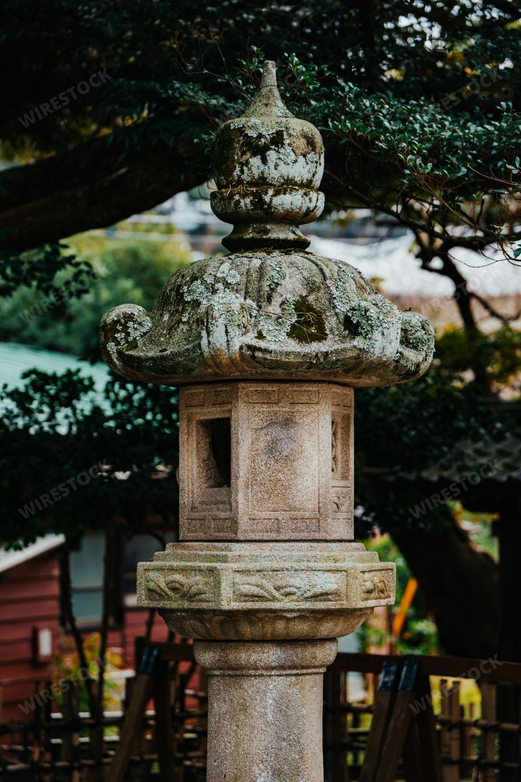 A Japanese Ishi-doro stone lantern in Japan and trees in the background