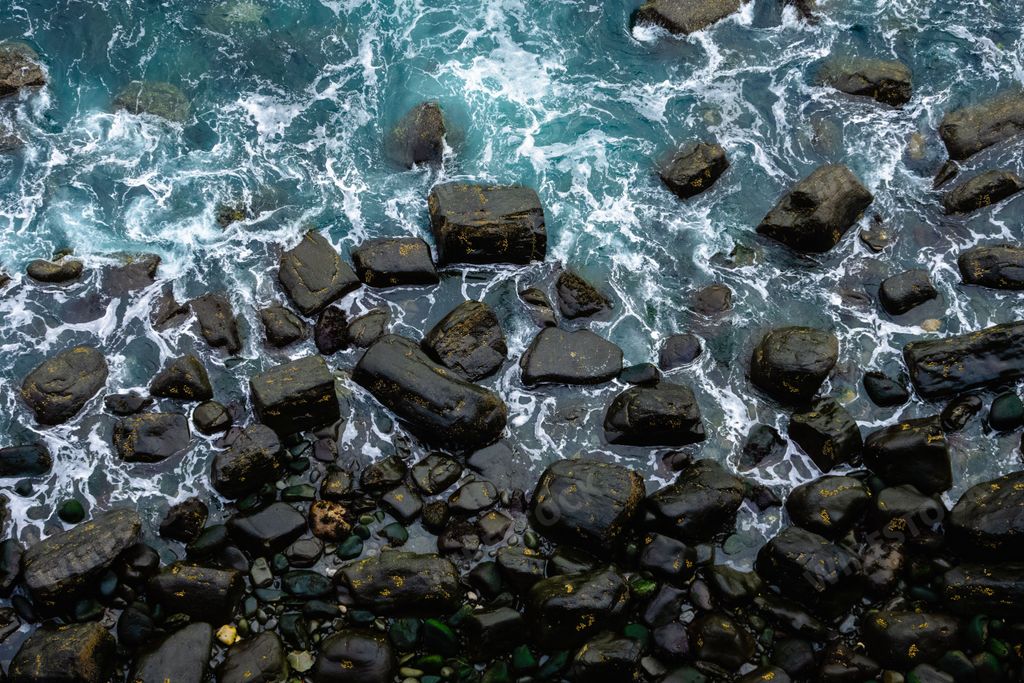 The blue water surface with rocks.  Mealt Falls, Isle of Skye, Scotland, UK.
