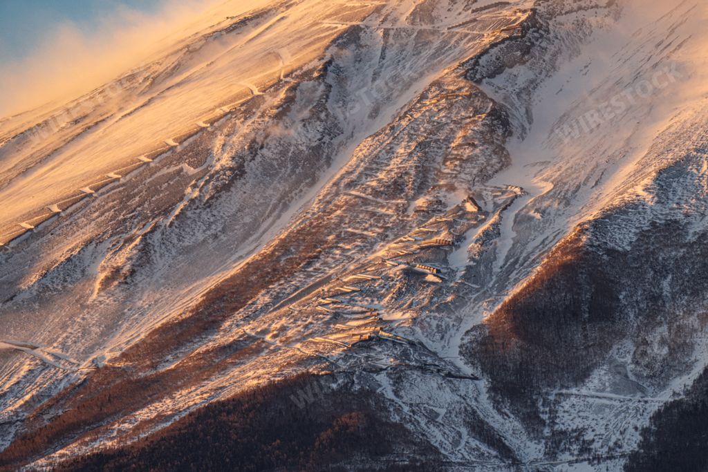 A scenic close-up of snow-covered trail and buildings on Mount Fuji in Fujikawaguchiko, Japan.