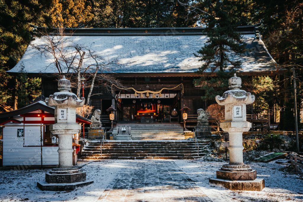 Kawaguchi Asama Shinto shrine surrounded by massive ancient sacred cedar trees and lush green plants.