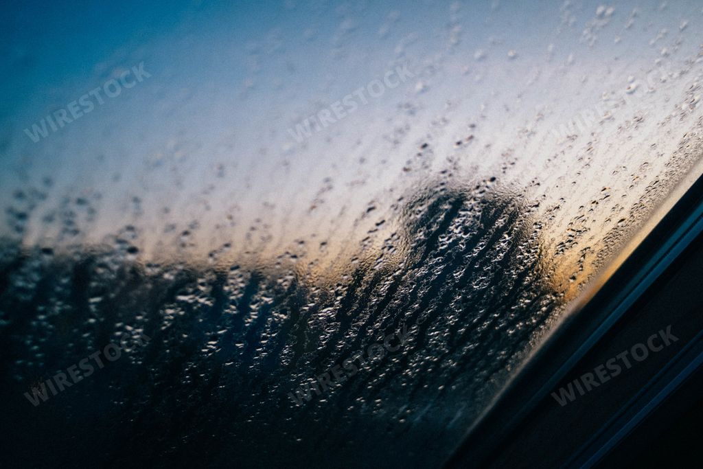 A wet window glass with drops of rain perfect for a seasonal background
