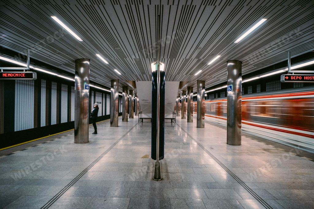 A metro station with a blurred metro train in the movement
