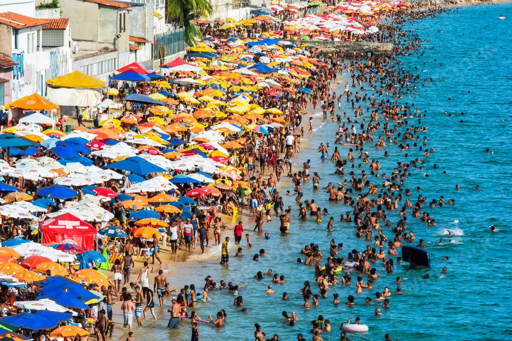 A group of people on the beach at Porto da Barra in Salvador, Bahia, Brazil at summertime
