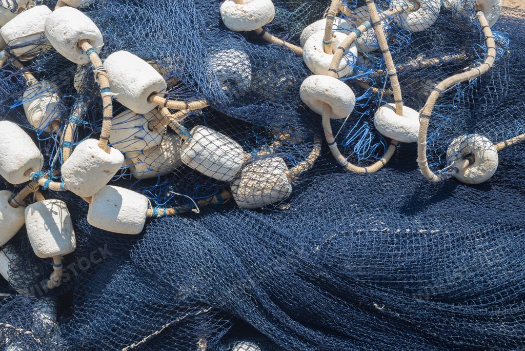 A closeup shot of a pile of fishing nets on a pier
