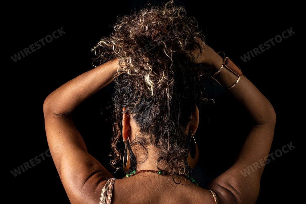 Afro-Brazilian model portrait in studio with black background. Concept of awareness, maturity and femininity. Salvador Bahia Brazil.