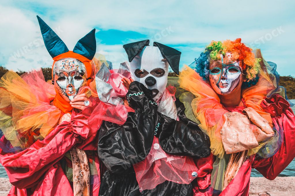 A group of people wearing a carnival costume and mask during Carnaval de Maragojipe in Brazil