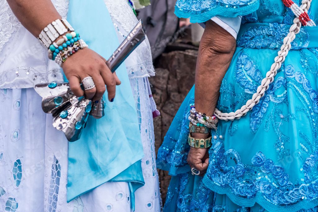 A vibrant group of people wearing traditional clothing from the Filhos de Gandy Carnival group in Salvador, Bahia