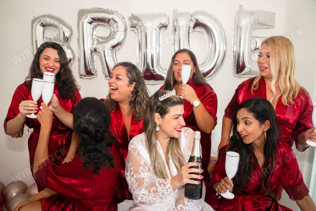 A portrait of a bride and bridesmaids against white background with Bride balloon in Brazil