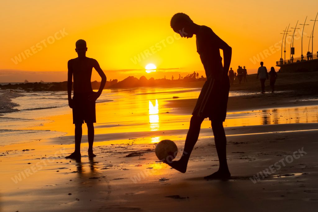 A group of Young people playing sand football at sunset on Ondina beach in Salvador, Bahia, Brazil