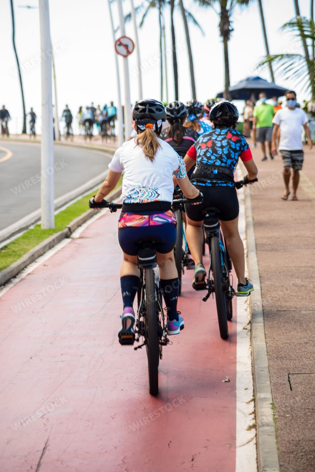 A beautiful shot of several cyclists on the Farol da Barra bike path in Salvador, Bahia, Brazil