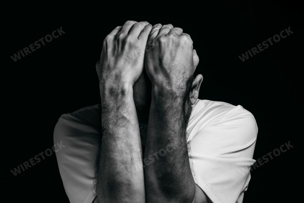 A sad depressed man against a dark background