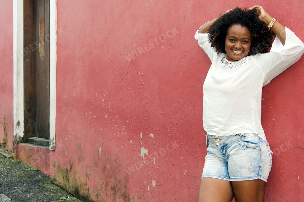 A beautiful Brazilian girl posing against a wall in Salvador, Brazil