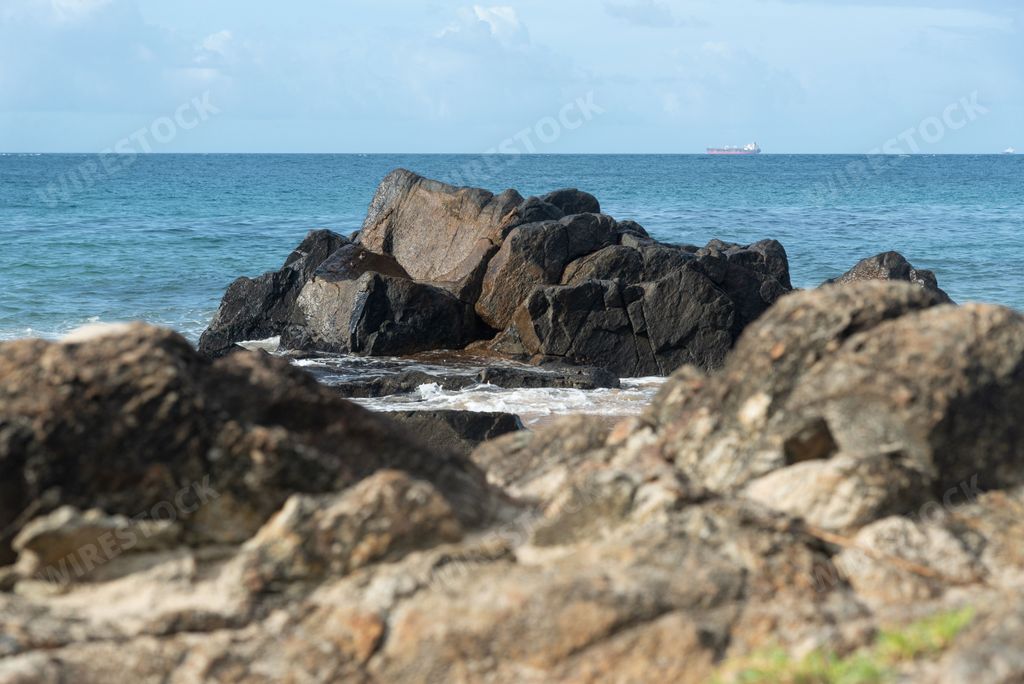A beautiful shot of stone formations on Farol da Barra beach, Salvador, Brazil