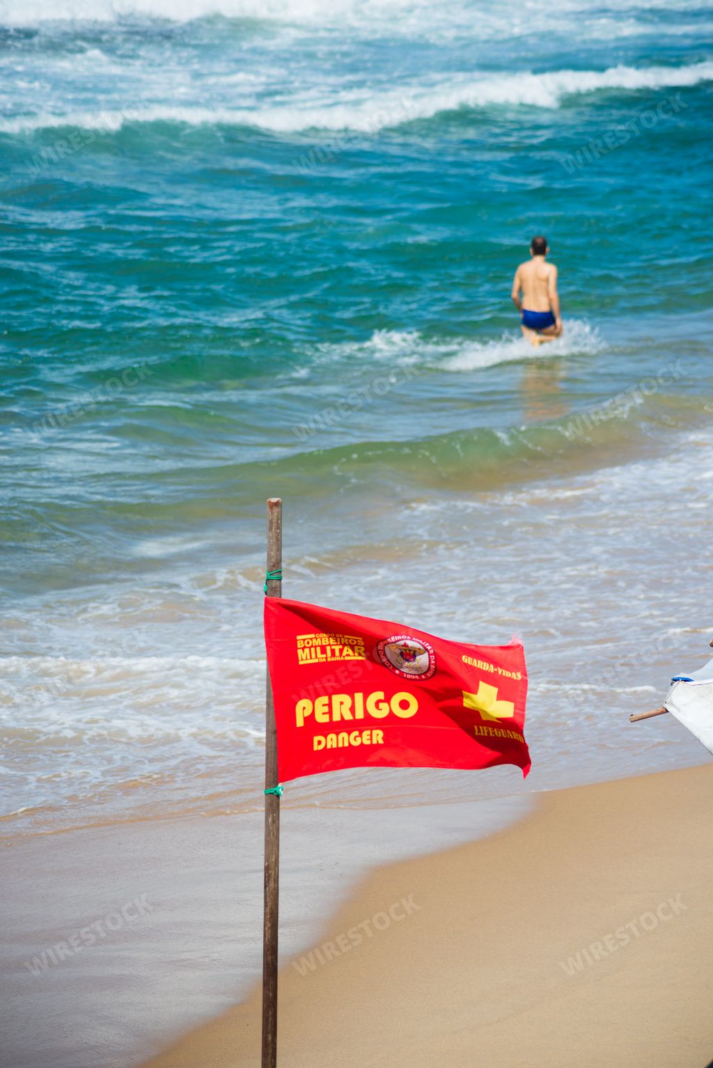 A closeup of Danger signs on Farol da Barra beach in the Brazilian city of Salvador