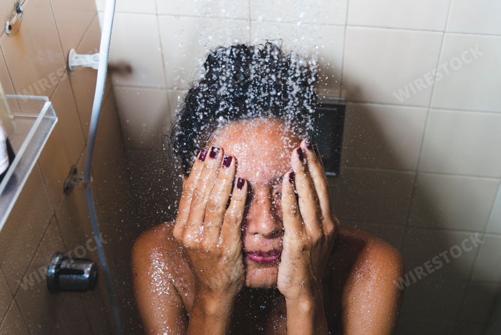 A closeup shot of the beautiful female taking a shower in Salvador, Brazil