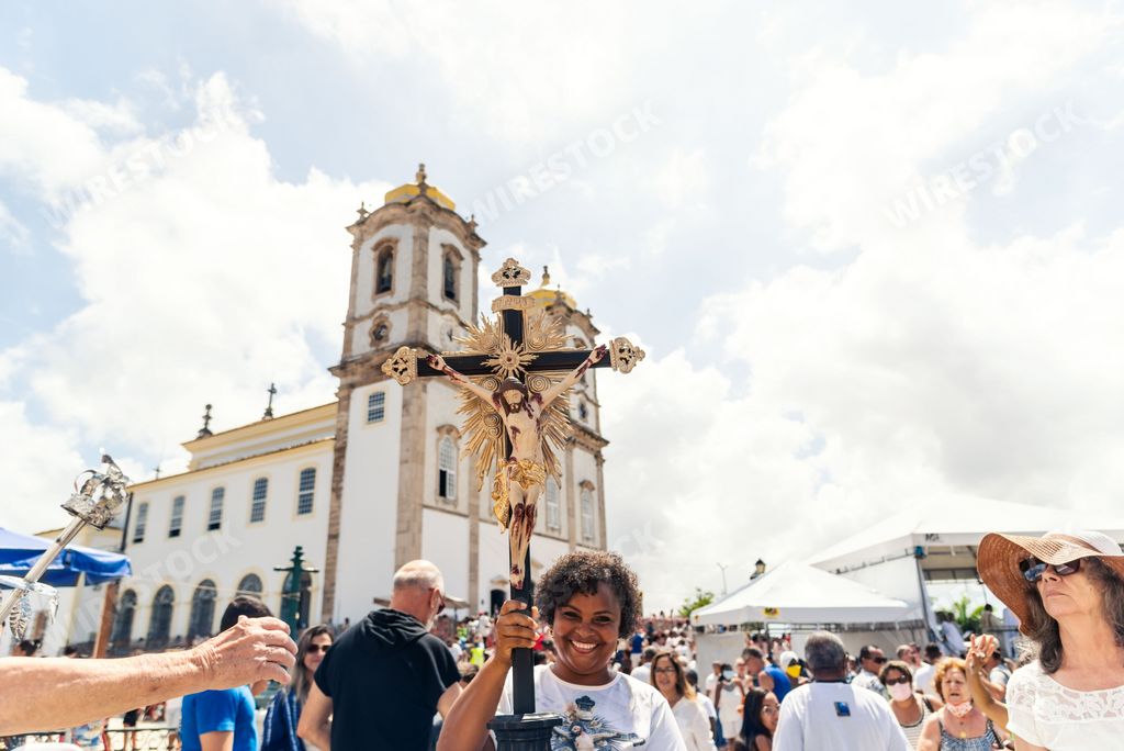 A person holding a crucified Jesus cross at a festival in Salvador, Brazil