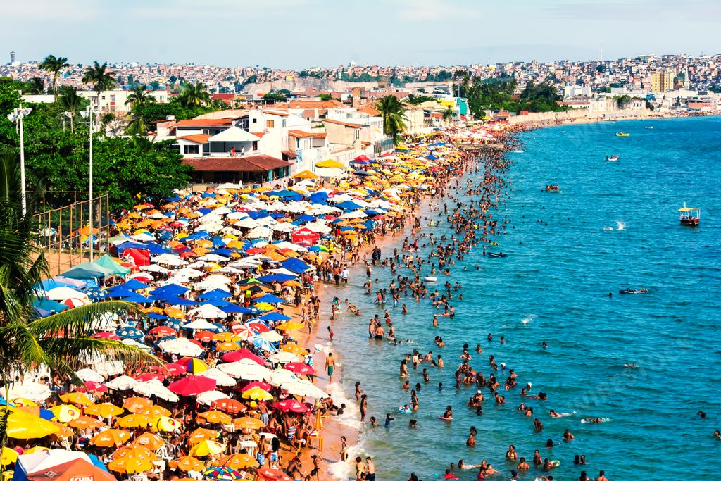A group of people on the beach at Porto da Barra in Salvador, Bahia, Brazil at summertime