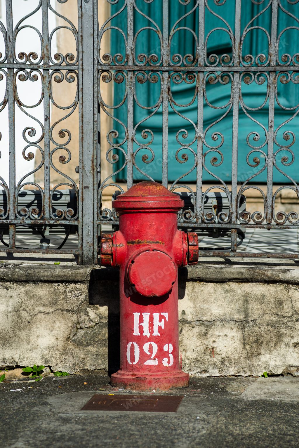 A vertical closeup of an old red fire hydrant in the streets of Pelourinho, Salvador, Bahia, Brazil