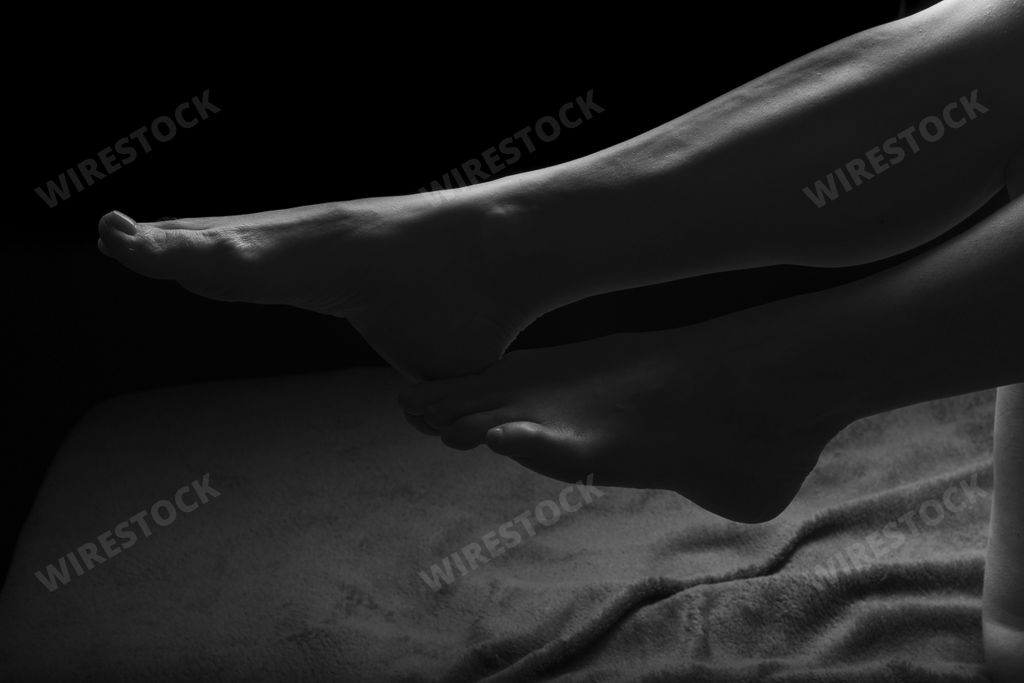 Female Nude silhouette. Black and white portrait. Part of the womans legs. Sexy mature woman. Young adult with Naked Body.