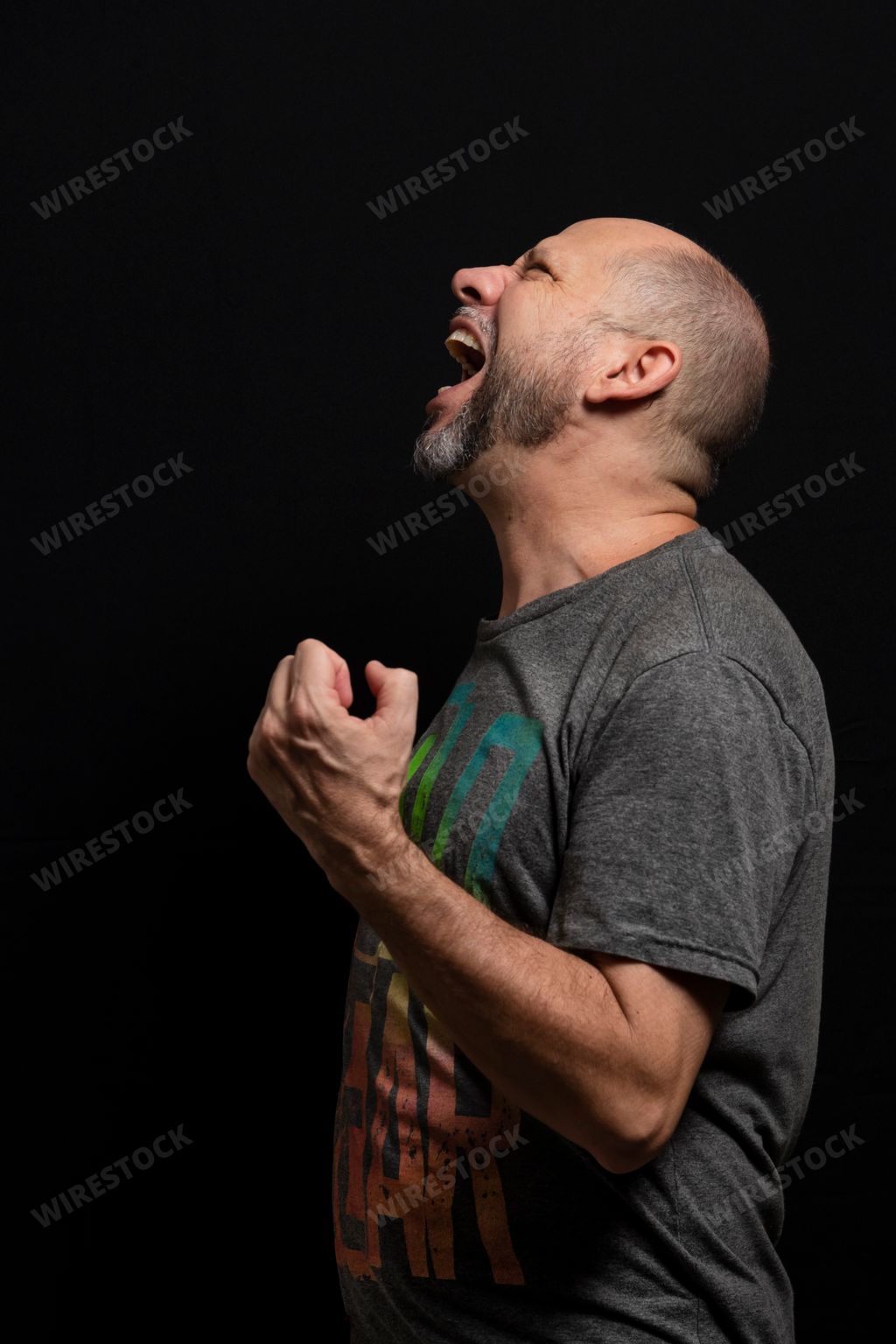 A portrait of a man standing against a black background in Salvador, Bahia, Brazil