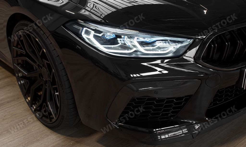 The headlights of a BMW M8 Competition