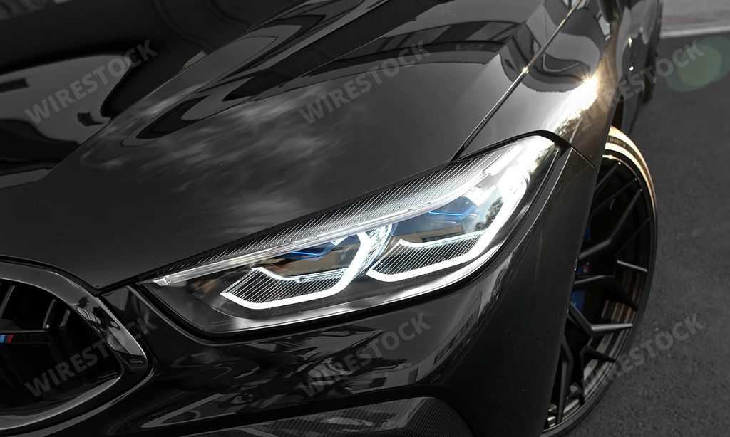 The headlights of a BMW M8 Competition