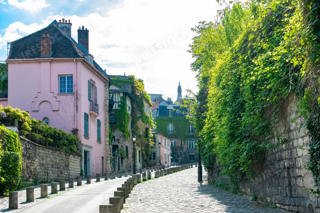Paris, France, famous pink house and buildings in Montmartre, in a romantic street