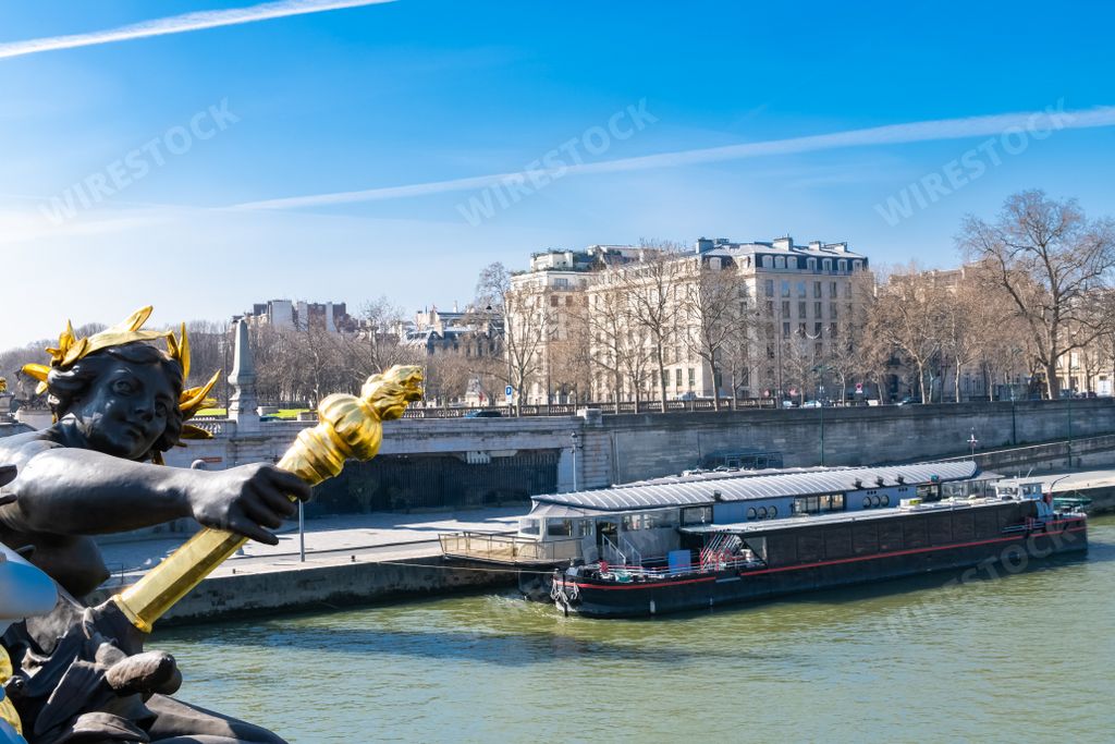 Paris, the Alexandre III bridge on the Seine, with houseboats on the river
