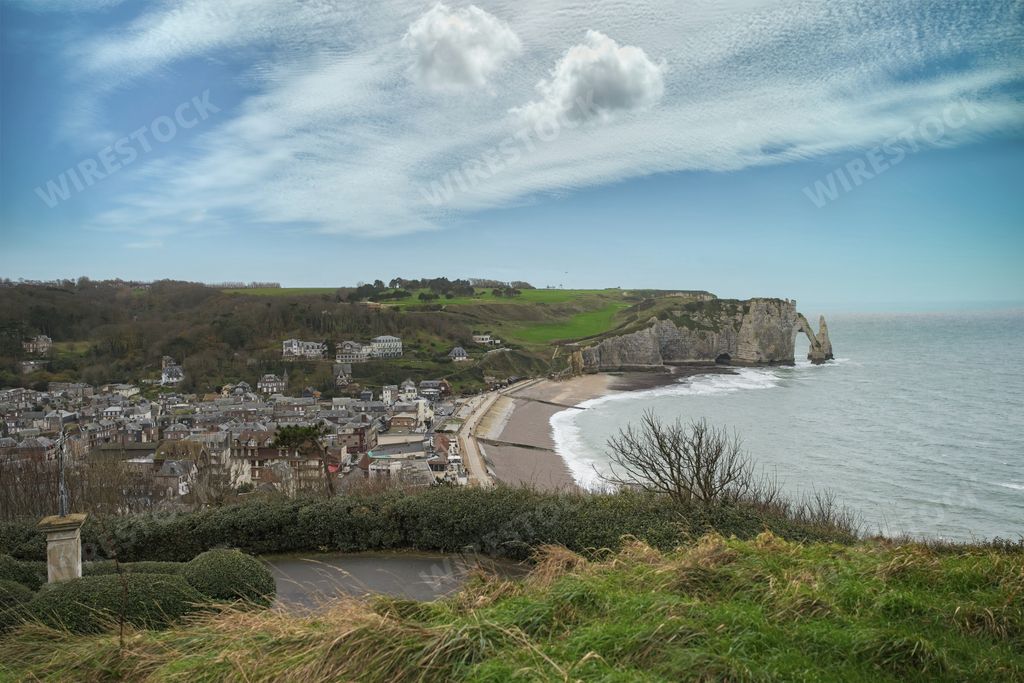 A scenic view of Etretat in Normandy, with cliffs and on pebble beach