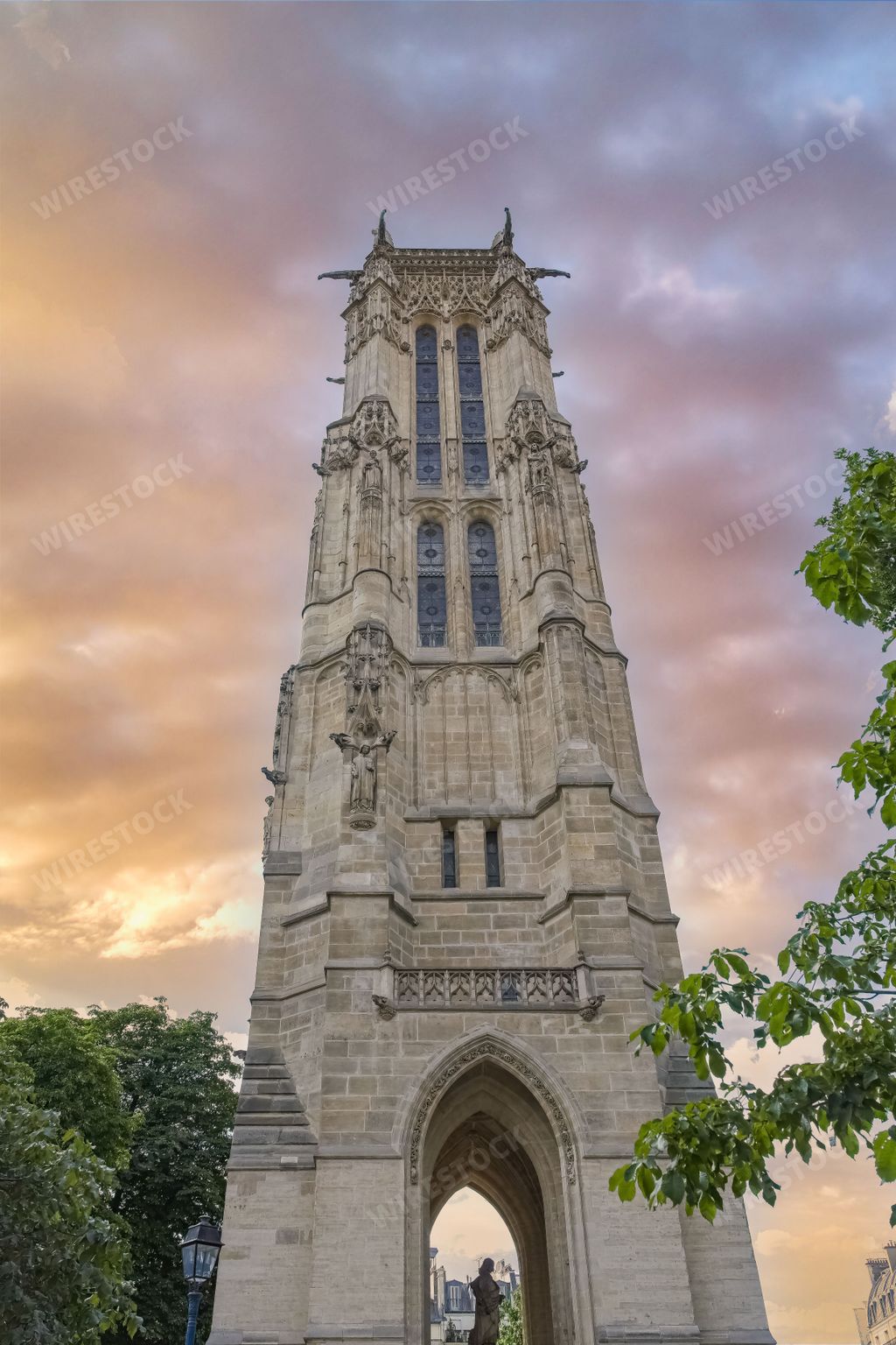 A vertical shot of the the Saint-Jacques tower under a sunset sky in Paris, France