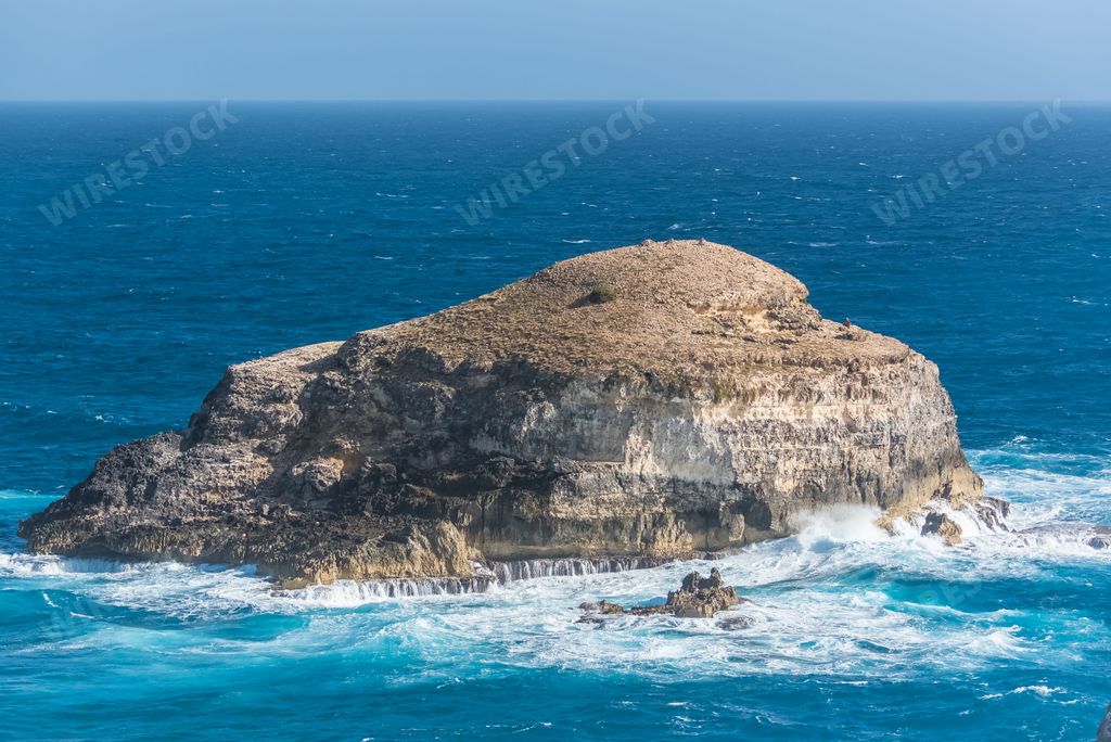 A big waves hitting the rocks in the island