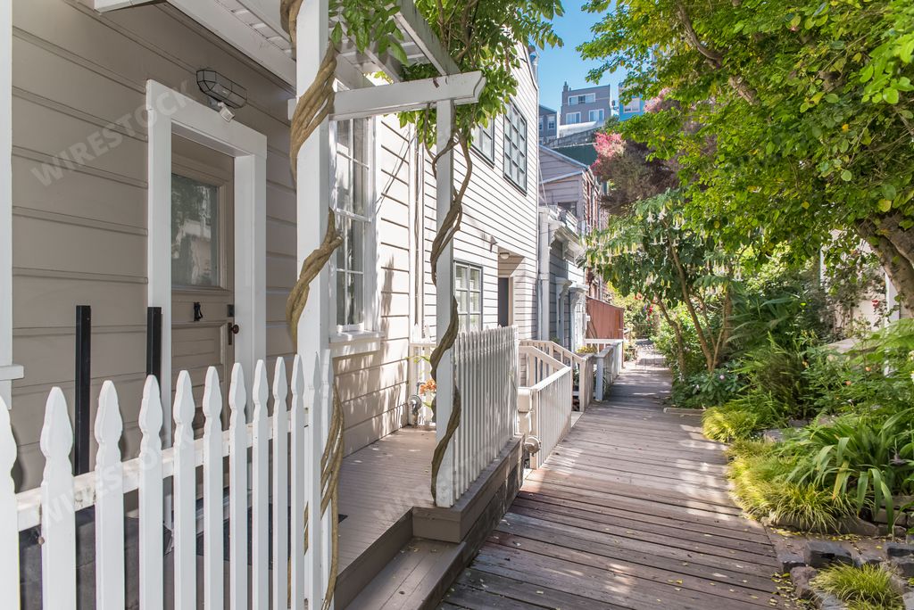 San Francisco, charming wooden staircase in Napier Lane, Telegraph Hill, with the Oakland Bay Bridge in background