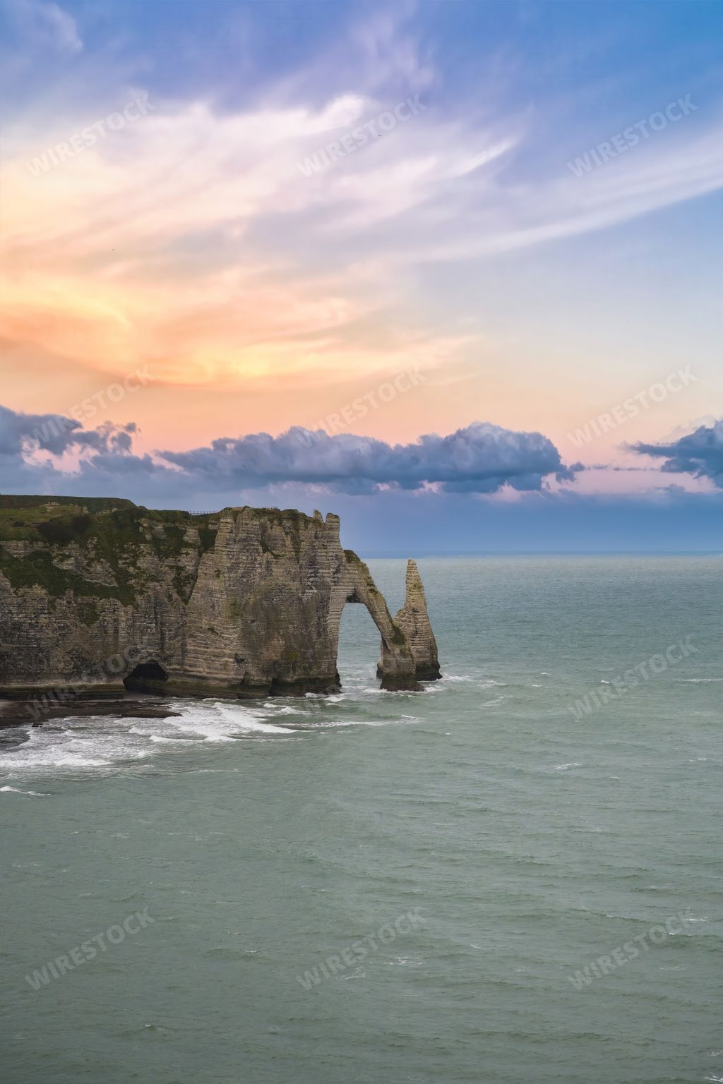 A scenic view of the famous cliffs and needle on the pebble beach at Etretat in Normandy