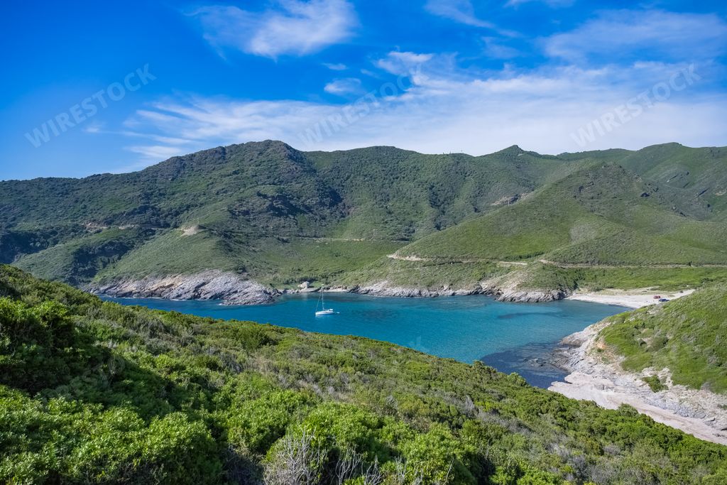 Corsica, seascape in the cap Corse, a beautiful creek with a boat, transparent water,  in summer