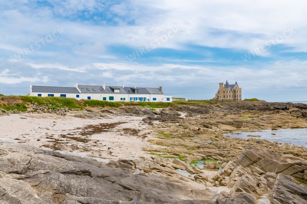 The Turpault castle at Quiberon peninsula, with traditional houses on the coast