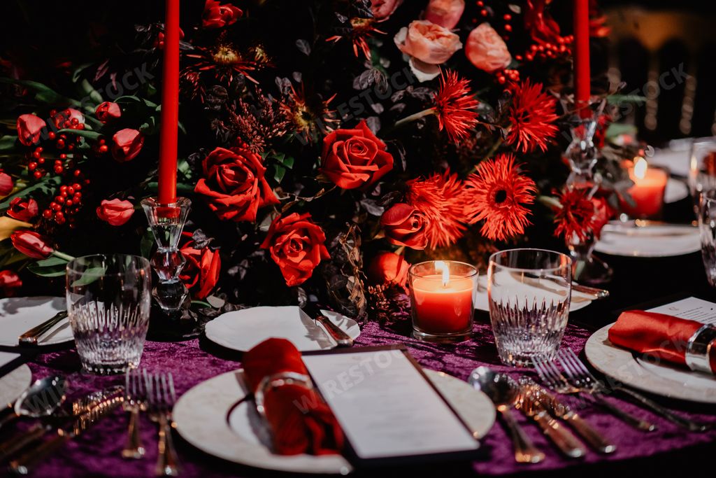 A selective of dining tables decorated with candles in the dark restaurant