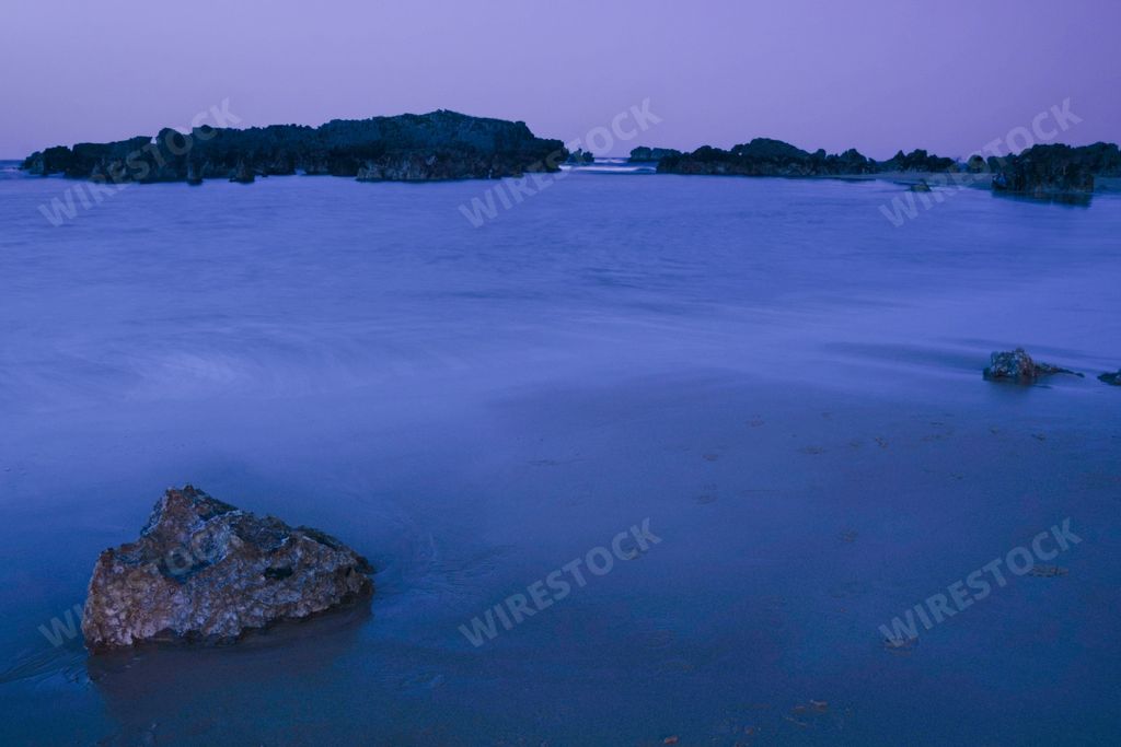 stones formation in the beach in Noja, Spain at sunset