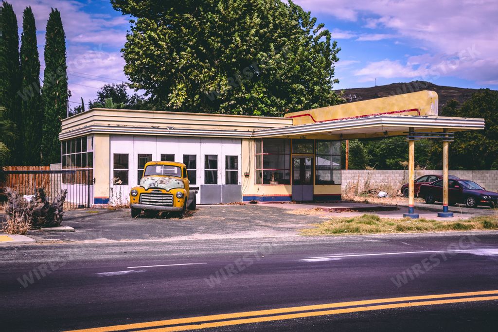 A beautiful view of Lost Gas Station in Mojave Desert, Nevada, United States with trees and a blue sky