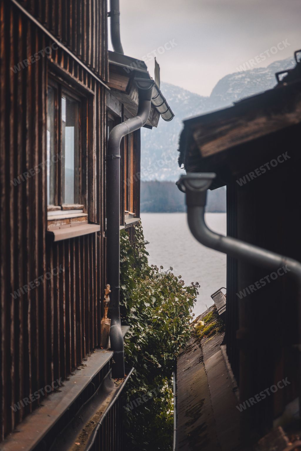 Wooden traditional chalets roofs in Hallstatt street in Austria with Austria alps on the horizon